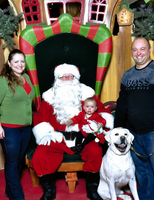Family holiday photo of Kris, his wife, daughter, dog, and Santa